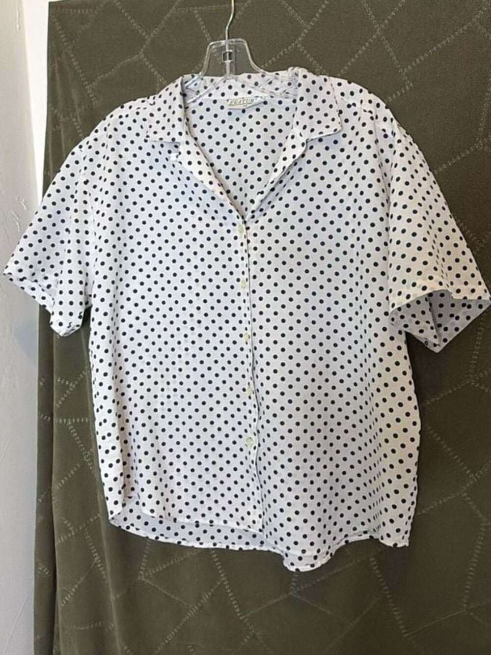 Features Vintage White and Navy Polka Dot Short Sleeve Button-Down Blouse